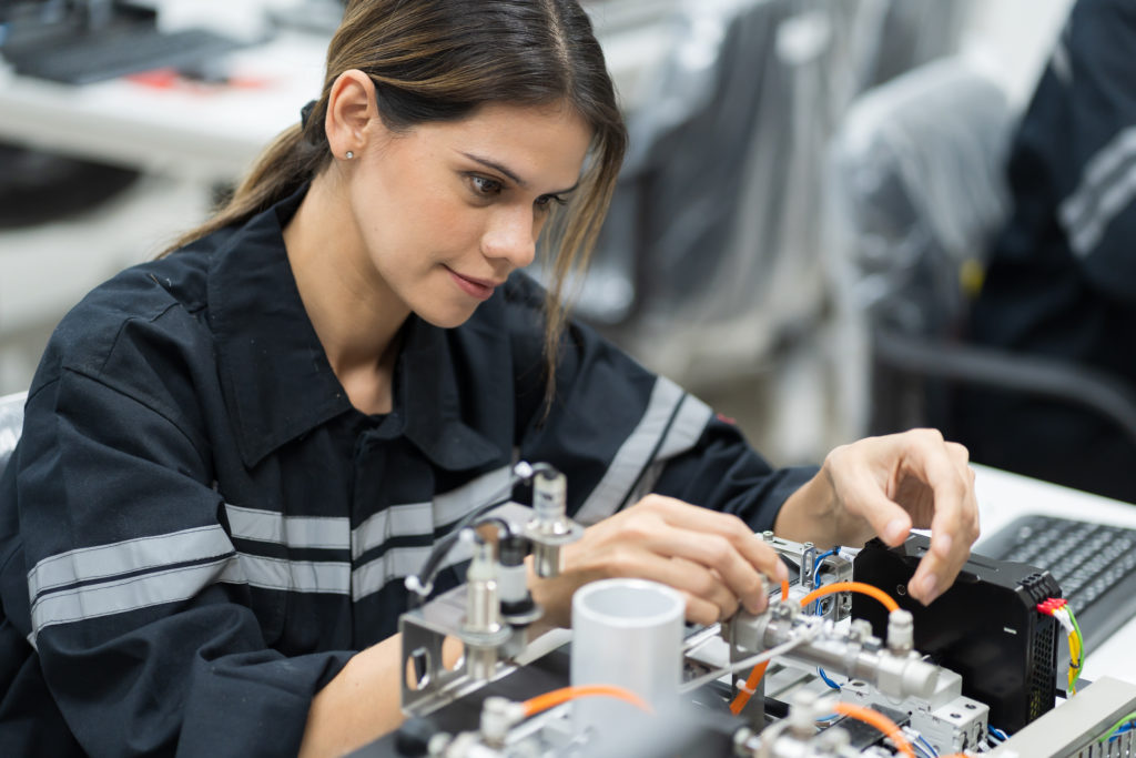 Innovation takes place as a female engineer is training a robot training kit
